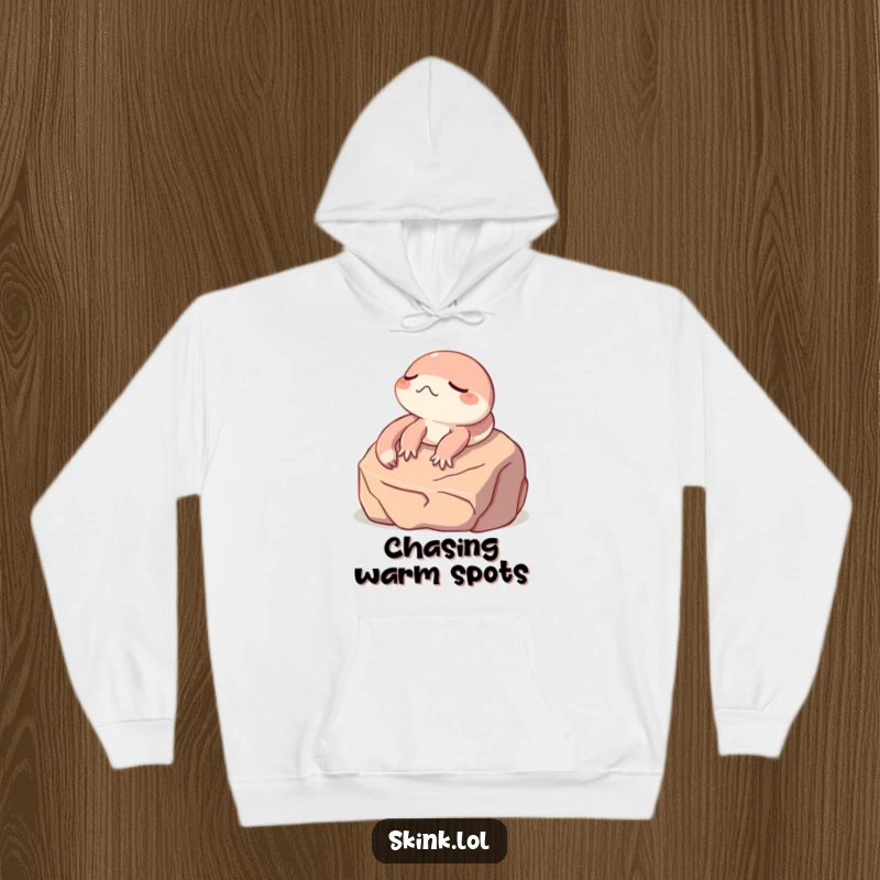 Funny skink hoodie, eyes shut, soaking up sun on a rock, cozy and humorous apparel for gifting.